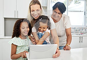 Blended family, adoption and a girl with her mother on a tablet in the kitchen for education or learning. Children