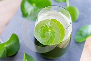 Blended green pennywort , asiatic juice with green background.