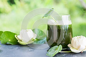 Blended green pennywort , asiatic juice with green background.