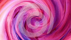 Blended red and blue ink in the background of water on a white background, while creating beautiful swirl shapes.