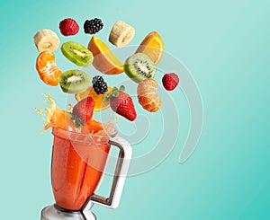 Blender with fruit flying, on blue background