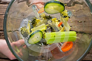 Blender mixes fresh vegetables for smoothies, healthy eating, detox
