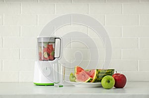 Blender and smoothie ingredients on counter in kitchen