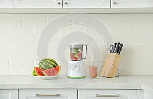 Blender and smoothie ingredients on counter in kitchen