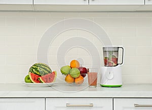 Blender and smoothie ingredients on counter in kitchen