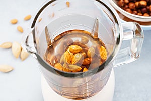 Blender with soaked almonds for making nut milk