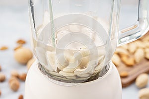 Blender with soaked cashews for making nut milk