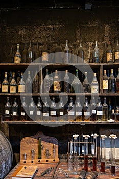 Blending process of cognac spirit and old French oak barrels in cellar in old distillery in Cognac white wine region, Charente,