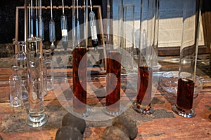 Blending process of cognac spirit and old French oak barrels in cellar in old distillery in Cognac white wine region, Charente,