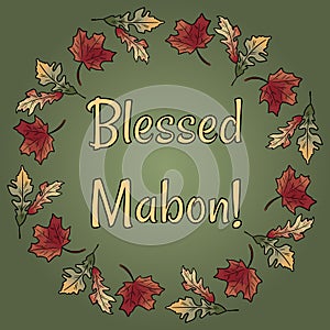 Blessed Mabon pagan holiday in fall leaves wreath ornament. Autumn orange and red foliage photo