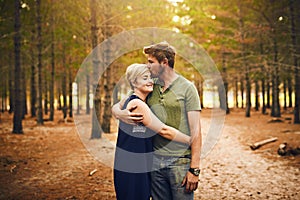 We are blessed to be together. Shot of a loving couple embracing each other in a hug while standing outside in the woods