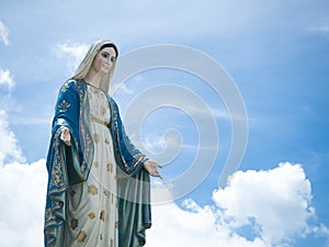 The Blessed Virgin Mary Statue blue sky background.