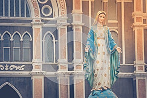 The Blessed Virgin Mary statue standing in front of The Roman Catholic Diocese that is public place.