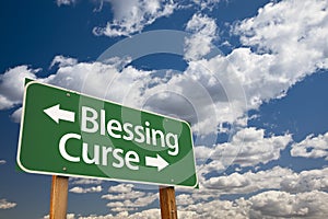 Blessing, Curse Green Road Sign and Clouds