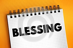 Blessing is the impartation of something with grace, holiness or spiritual redemption, text concept on notepad photo