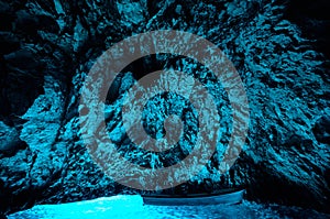 Bleu cave in Croatia, Croatian wonder, landmark. Tourist visiting the inside of the Blue cave, Bisevo island, light of