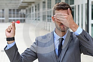 Blind businessman holding a dart