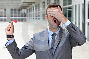 Blind businessman holding a dart