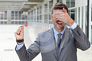 Blind businessman holding a dart