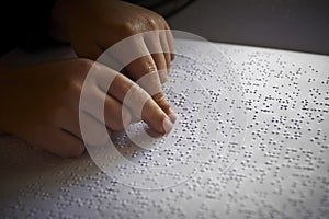 Blind children read text in braille