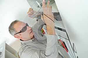 Blind man alone in kitchen