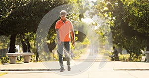 Blind Man Crossing The Street And Walking With Cane