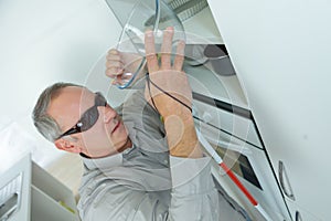 Blind man in kitchen