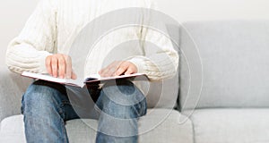 Blind man reading braille book.