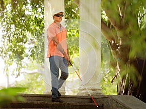 Blind Man Walking And Descending Steps In City Park