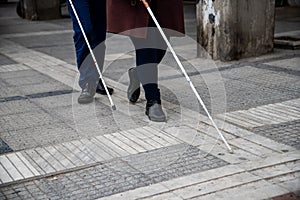 Blind man and woman walking on the street