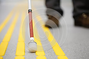 Blind pedestrian walking on tactile paving