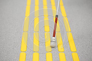 Blind pedestrian walking on tactile paving