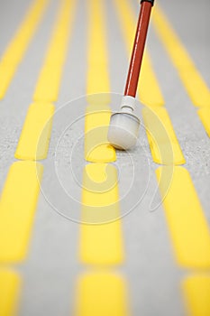 Blind pedestrian walking on tactile paving