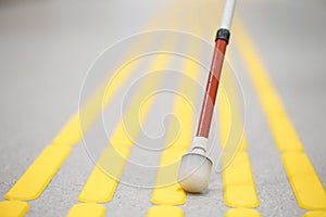 Blind pedestrian walking on tactile paving