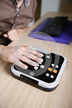 Blind person using audio book player for visually impaired photo