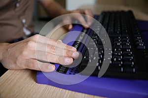 Blind person using computer with braille computer display