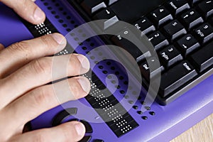 Blind person using computer with braille computer display