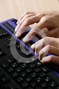 Blind person using computer with braille computer display photo