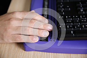 Blind person using computer with braille computer display photo