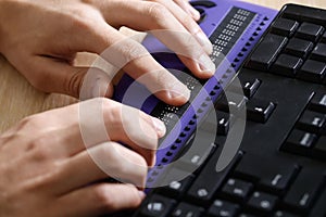 Blind person using computer with braille computer display