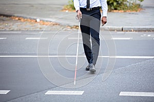 Blind Person Walking On Street photo