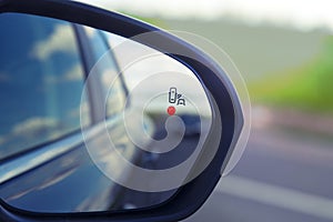 Blind Spot Monitoring system warning light icon in side view mirror of a modern vehicle photo