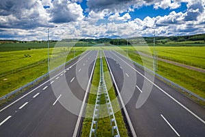 Blind street, road ending in the field. Concept of road building construction, highways building program or cut financing the buil