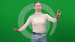 Blind woman moving hands on green screen. Portrait of ill Caucasian beautiful sightless lady touching invisible