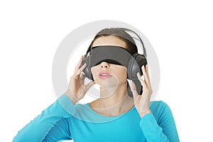 Blindfold attractive woman with headphones