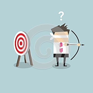 Blindfold businessman holding bow and arrow look for target in wrong direction.