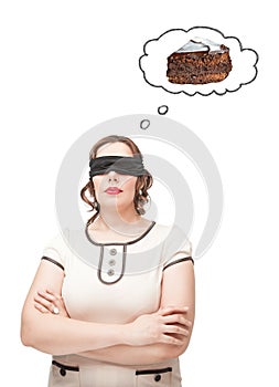 Blindfold plus size woman dreaming about cake