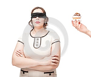 Blindfold plus size woman temptating with pastry