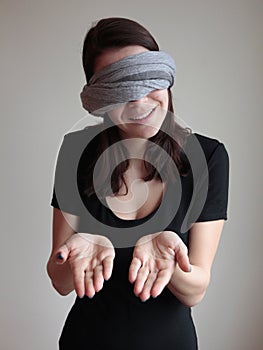 Blindfolded woman showing palms