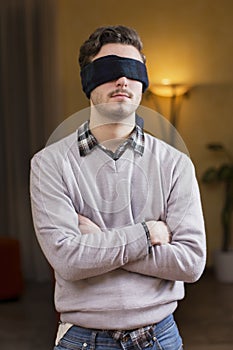 Blindfolded young man cannot see